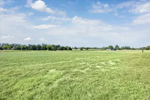 a view of a field with an ocean
