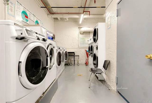 a view of a storage and utility room with washer and dryer