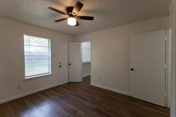 wooden floor in an empty room with a window