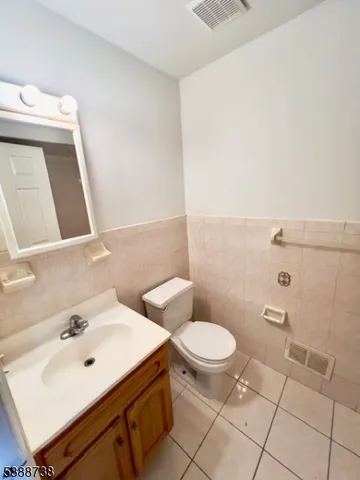 a bathroom with a sink toilet and mirror