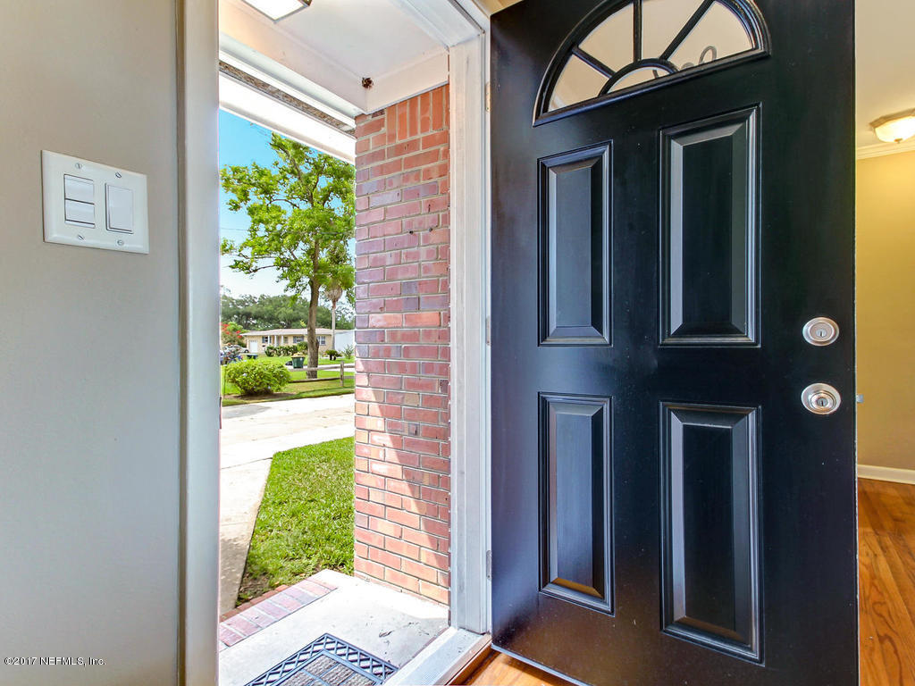 3754 Coronado Road Jacksonville, FL 32217 - Photo 2 of 19 a view of a porch with a floor to ceiling window and front of a house