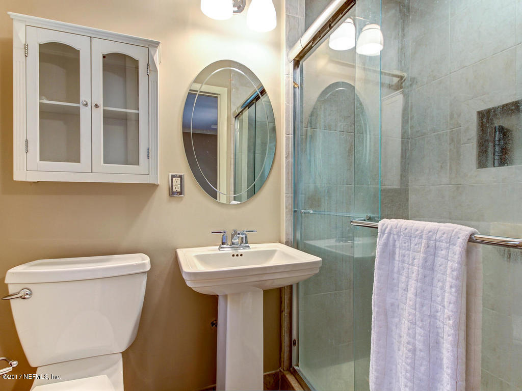 3754 Coronado Road Jacksonville, FL 32217 - Photo 11 of 19 a bathroom with a toilet sink and mirror