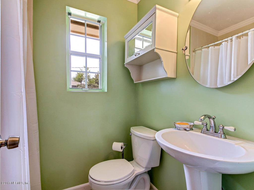 3754 Coronado Road Jacksonville, FL 32217 - Photo 14 of 19 a bathroom with a sink a mirror and a toilet