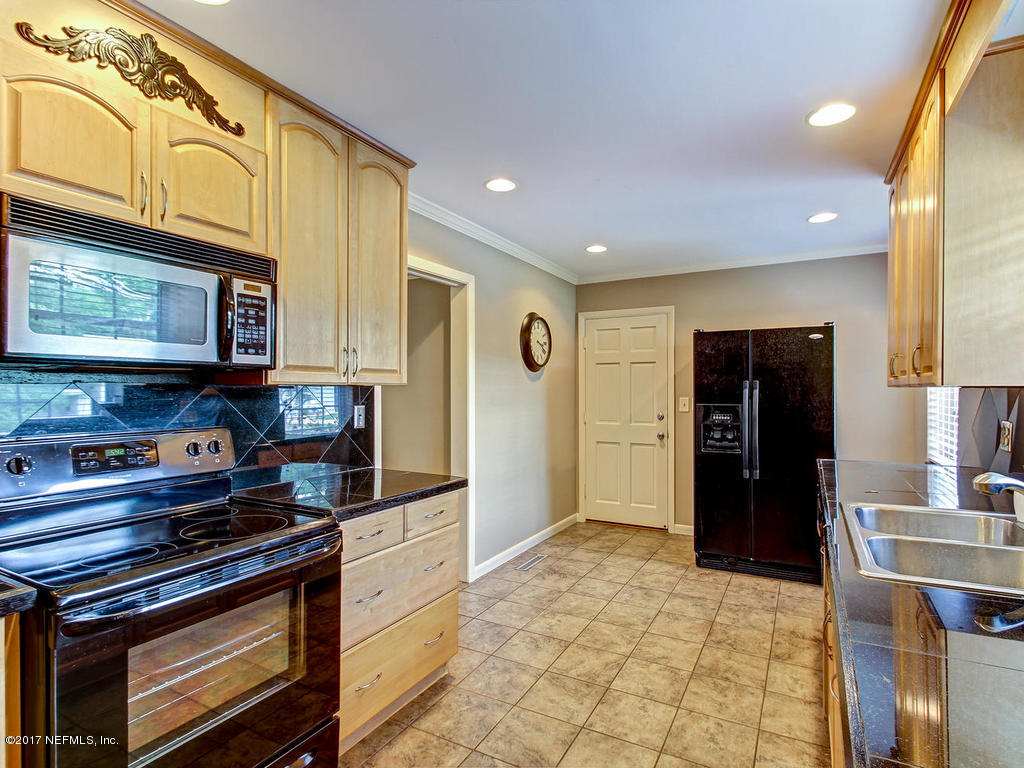 3754 Coronado Road Jacksonville, FL 32217 - Photo 3 of 19 a kitchen with stainless steel appliances granite countertop a stove and a refrigerator