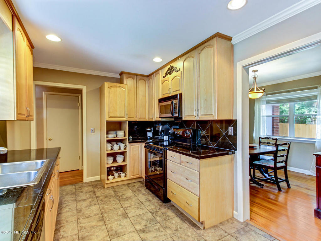 3754 Coronado Road Jacksonville, FL 32217 - Photo 8 of 19 a kitchen with a stove a sink and a refrigerator