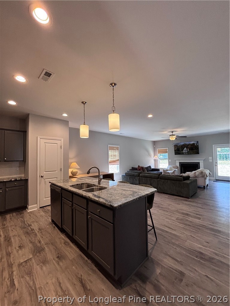 7720 Rufus Johnson Road Fayetteville, NC 28306 - Photo 25 of 50 a kitchen with stainless steel appliances granite countertop a sink a stove and a wooden floors
