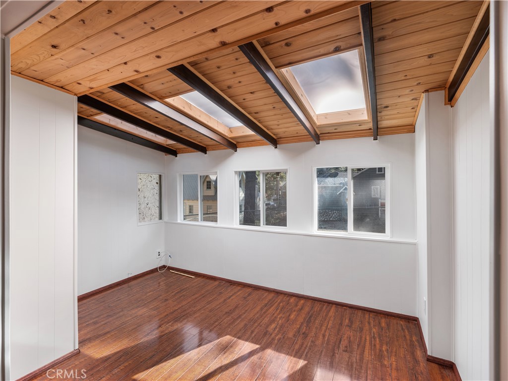 1725 Linnet Road Wrightwood, CA 92397 - Photo 17 of 43 a view of an empty room with wooden floor and a window