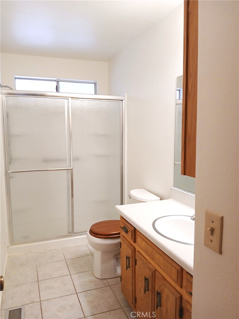 1725 Linnet Road Wrightwood, CA 92397 - Photo 20 of 43 a bathroom with a granite countertop sink toilet and shower