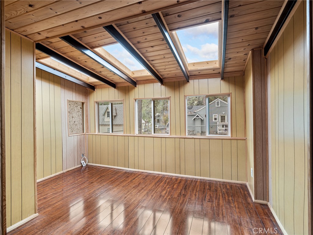 1725 Linnet Road Wrightwood, CA 92397 - Photo 10 of 35 a view of an empty room with wooden floor and windows