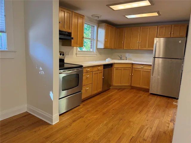 a kitchen with granite countertop stainless steel appliances and wooden cabinets