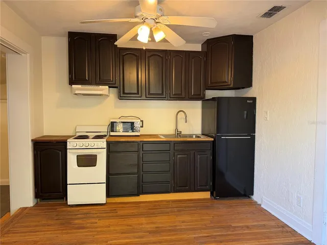 a kitchen with stainless steel appliances granite countertop a stove and a refrigerator