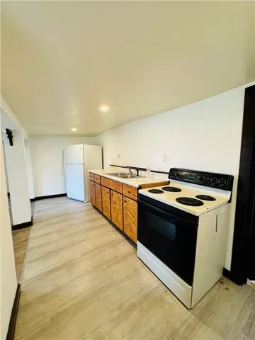 a kitchen with stainless steel appliances granite countertop a stove and a refrigerator