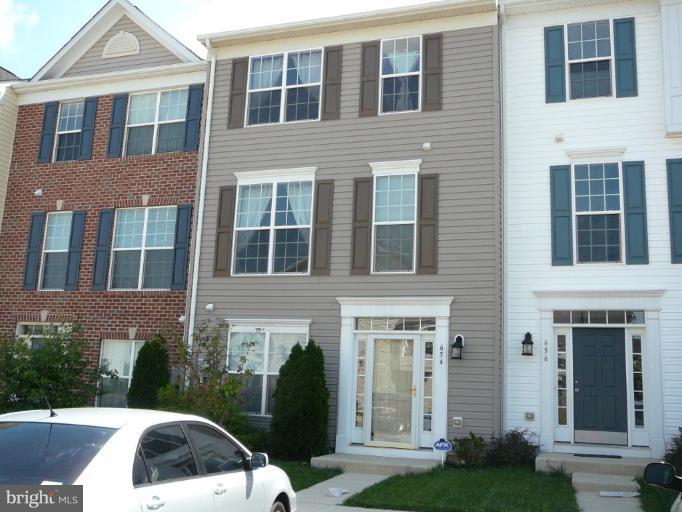 654 Wild Hunt Road Frederick, MD 21703 - Photo 1 of 17 a view of a brick building next to a yard
