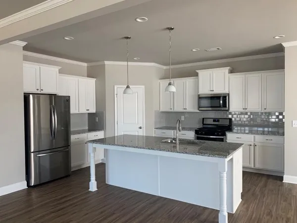 a kitchen with wooden cabinets and stainless steel appliances