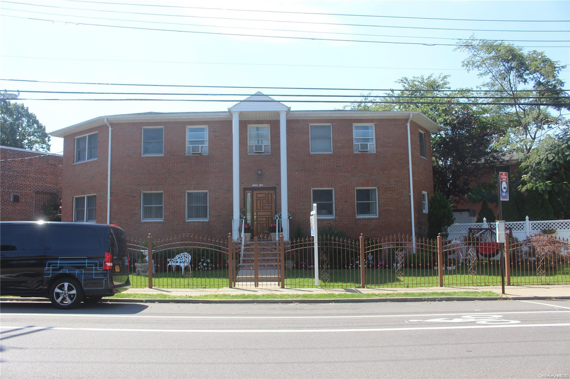 163-12 Pidgeon Meadow Road Queens, NY 11358 - Photo 1 of 1 a view of a house with a backyard and a car park side of a road