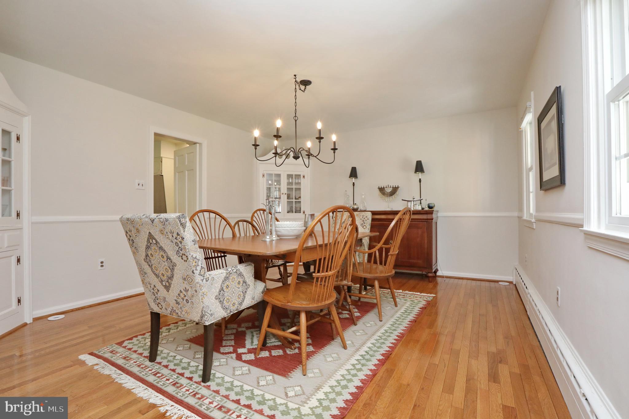 15111 Cactus Hill Road Accokeek, MD 20607 - Photo 16 of 44 a dining room with furniture a chandelier and wooden floor