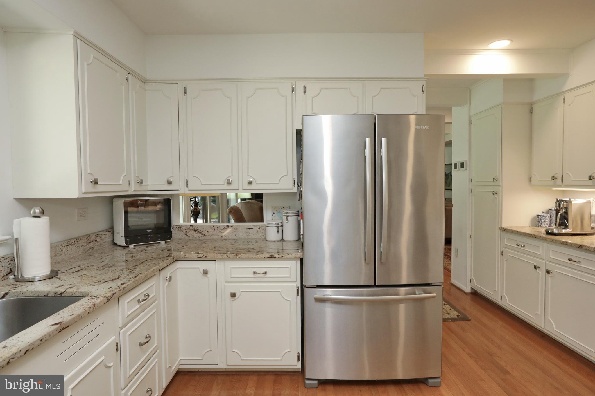 15111 Cactus Hill Road Accokeek, MD 20607 - Photo 19 of 44 a kitchen with stainless steel appliances granite countertop a refrigerator a stove a sink and white cabinets