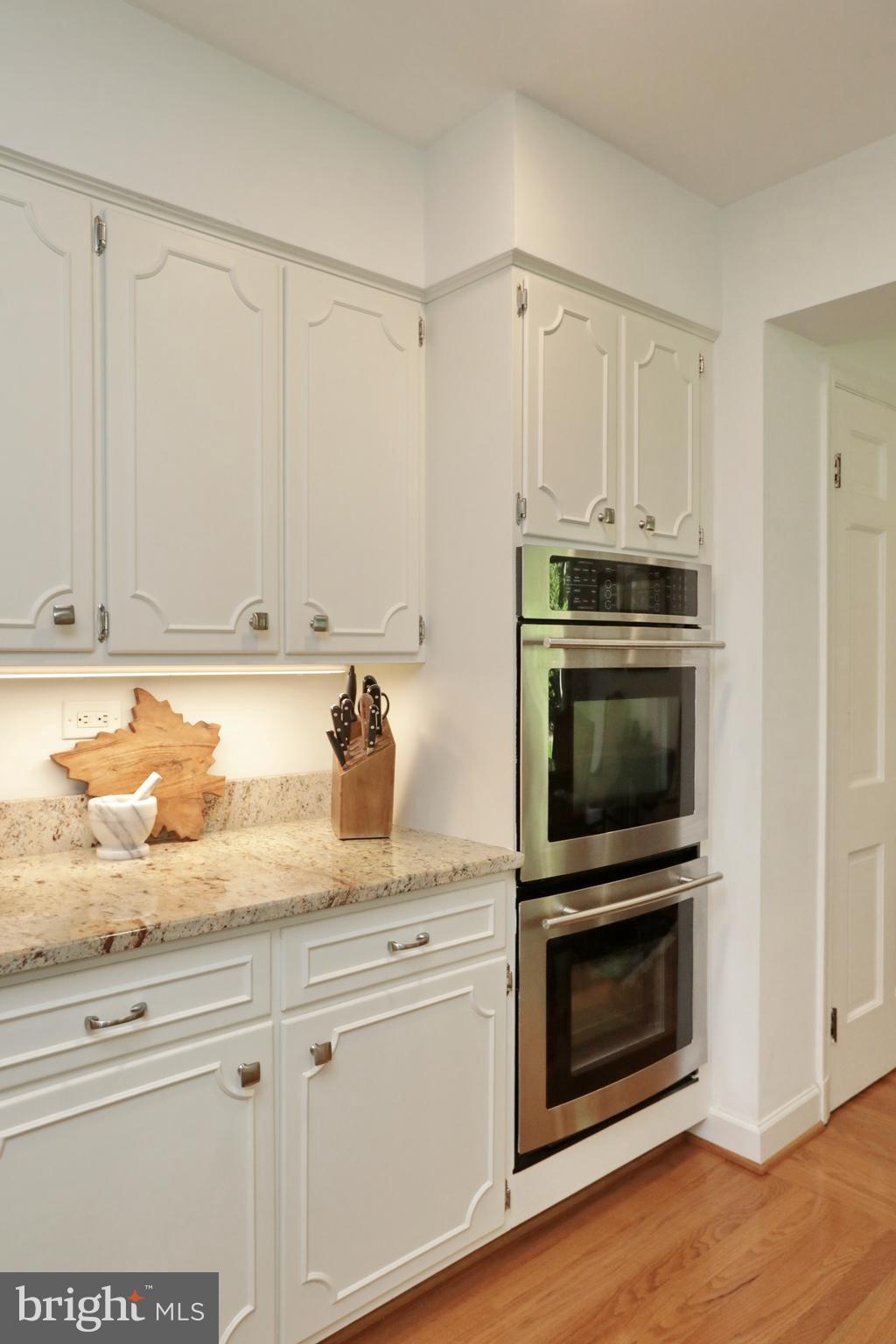 15111 Cactus Hill Road Accokeek, MD 20607 - Photo 20 of 44 a kitchen with granite countertop white cabinets and stainless steel appliances