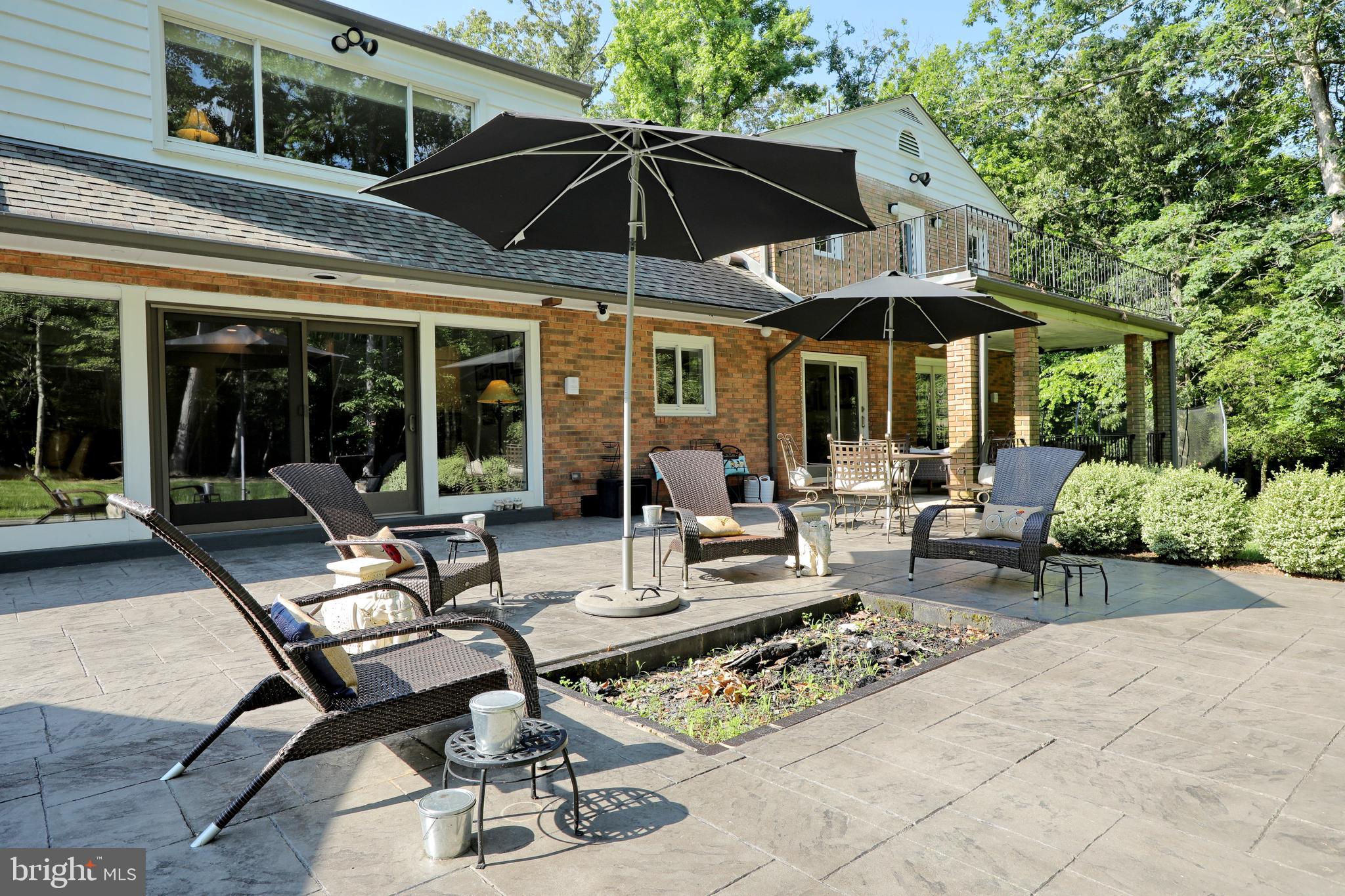 15111 Cactus Hill Road Accokeek, MD 20607 - Photo 6 of 44 a view of a patio with table and chairs under an umbrella