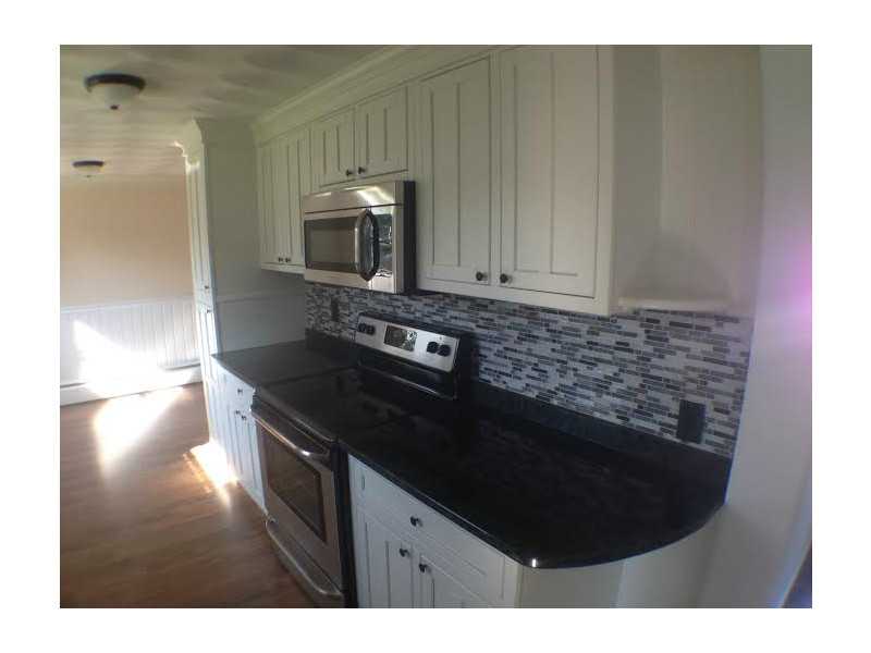 3 Hague Road Warwick, RI 02889 - Photo 6 of 19 Kitchen. Custom tile backsplash, brand new stainless appliances, granite countertops, new cabinets, perfect space planning