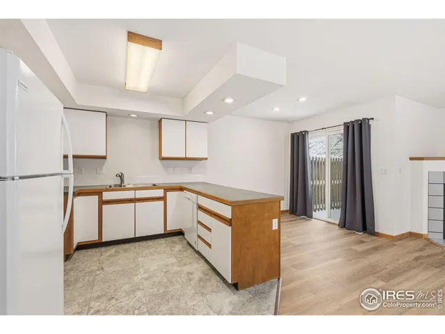 a kitchen with stainless steel appliances granite countertop a refrigerator a sink and a stove