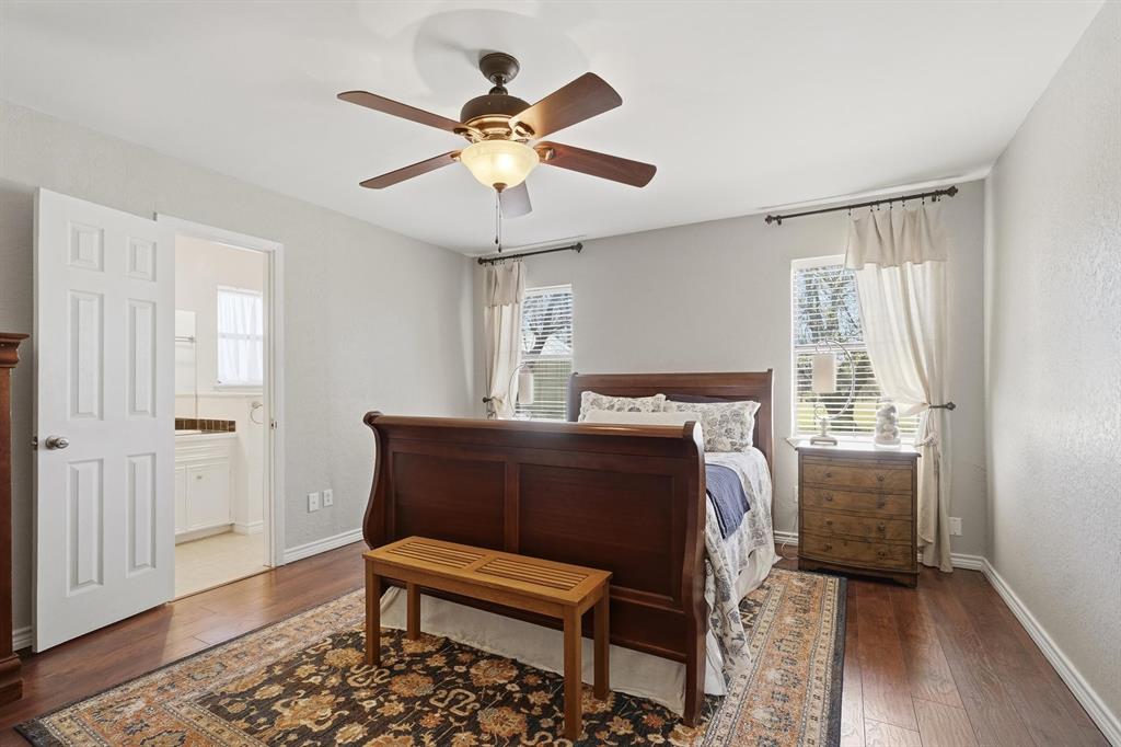 121 Sandy Lane Clyde, TX 79510 - Photo 15 of 30 a bedroom with a bed and a chandelier