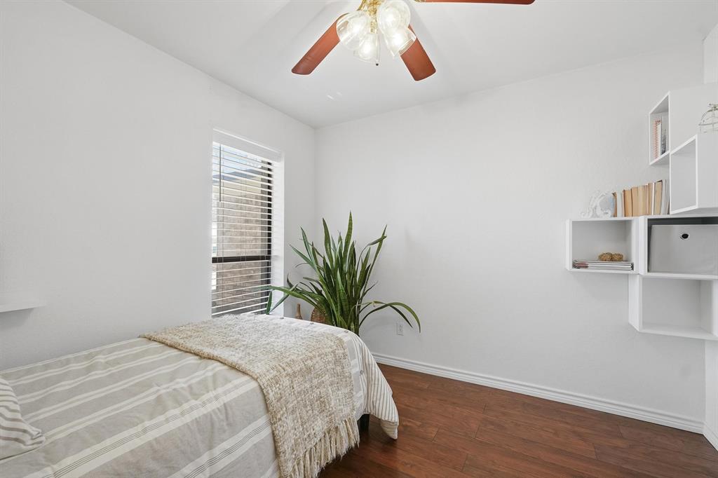 121 Sandy Lane Clyde, TX 79510 - Photo 24 of 30 a bedroom with a large bed and a potted plant