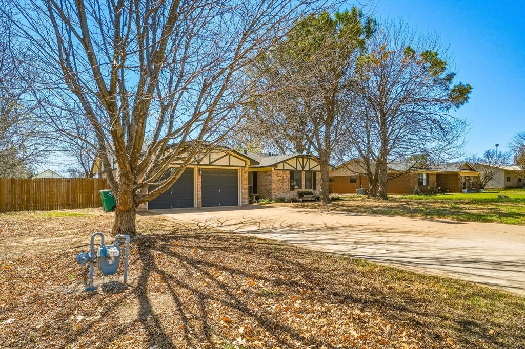 121 Sandy Lane Clyde, TX 79510 - Photo 3 of 30 a front view of a house with a yard covered with snow