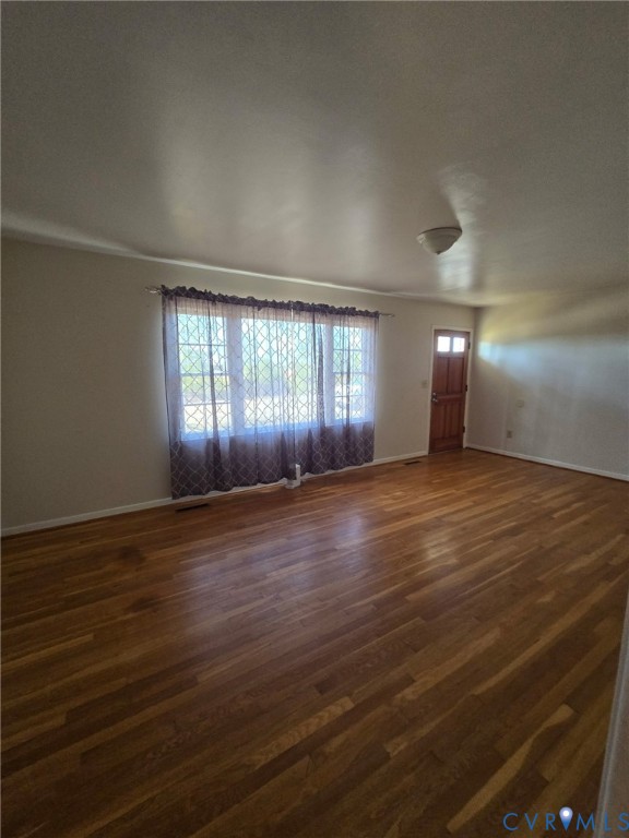 19247 Courthouse Road Yale, VA 23897 - Photo 4 of 6 Empty room with dark wood-style flooring and baseb