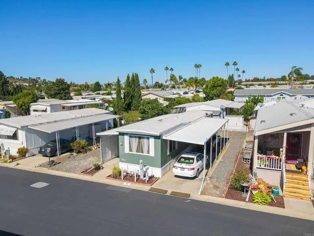 a aerial view of a house with a big yard and large trees
