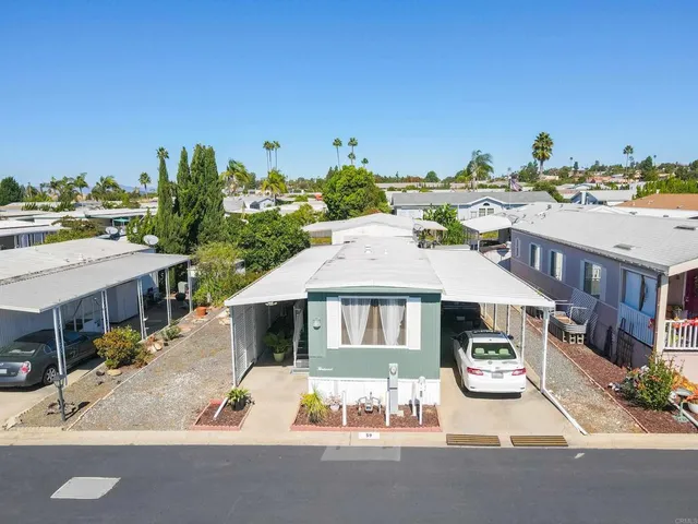 a front view of a house with a yard and seating area