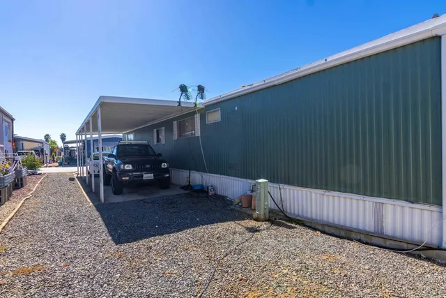 a backyard of a house with table and chairs