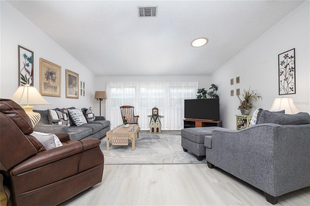 501 Topside Circle Edgewater, FL 32141 - Photo 11 of 47 a living room with furniture and a flat screen tv