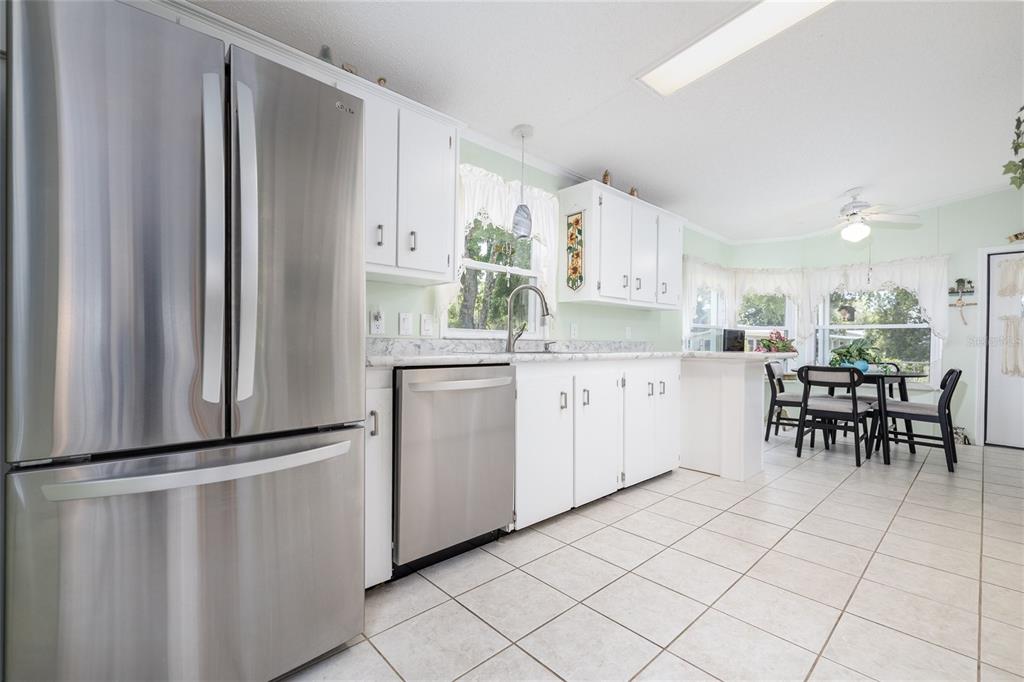 501 Topside Circle Edgewater, FL 32141 - Photo 14 of 47 a kitchen with white cabinets and white appliances
