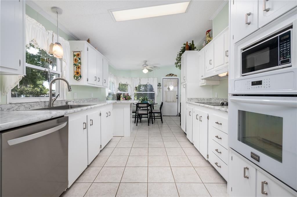 501 Topside Circle Edgewater, FL 32141 - Photo 15 of 47 a kitchen with stainless steel appliances kitchen island granite countertop a sink and cabinets