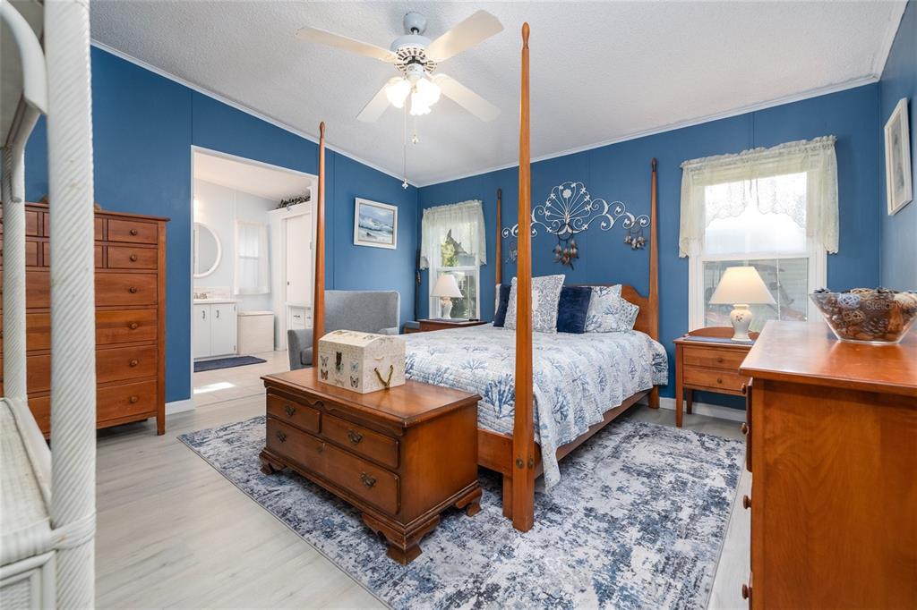 501 Topside Circle Edgewater, FL 32141 - Photo 17 of 47 a spacious bedroom with a bed and wooden floor