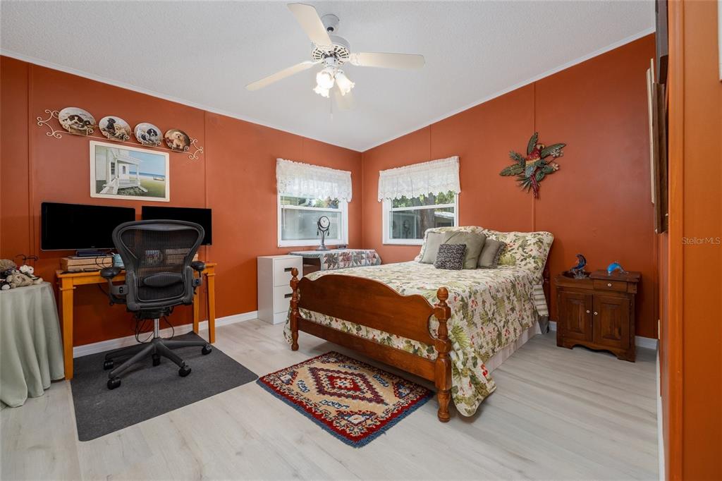 501 Topside Circle Edgewater, FL 32141 - Photo 21 of 47 a bedroom with a bed window and a desk