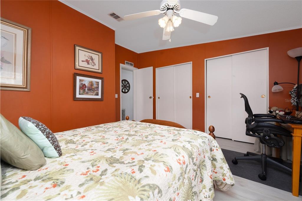 501 Topside Circle Edgewater, FL 32141 - Photo 22 of 47 a bedroom with a bed and a chandelier