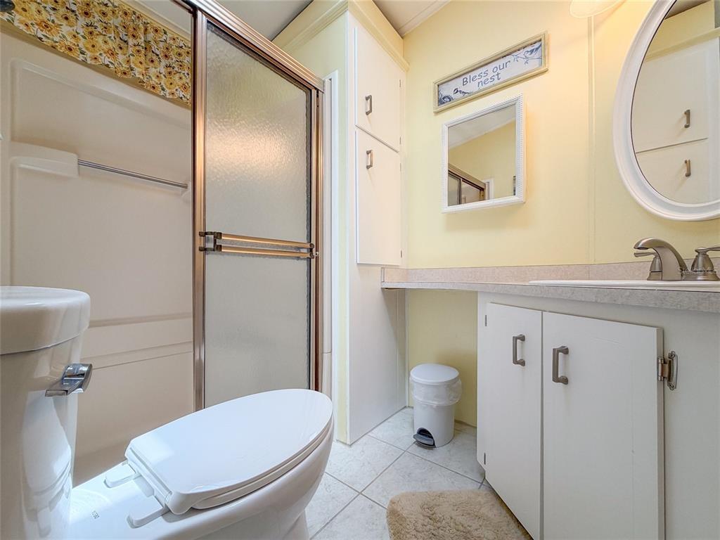 501 Topside Circle Edgewater, FL 32141 - Photo 23 of 47 a bathroom with a toilet a sink and mirror