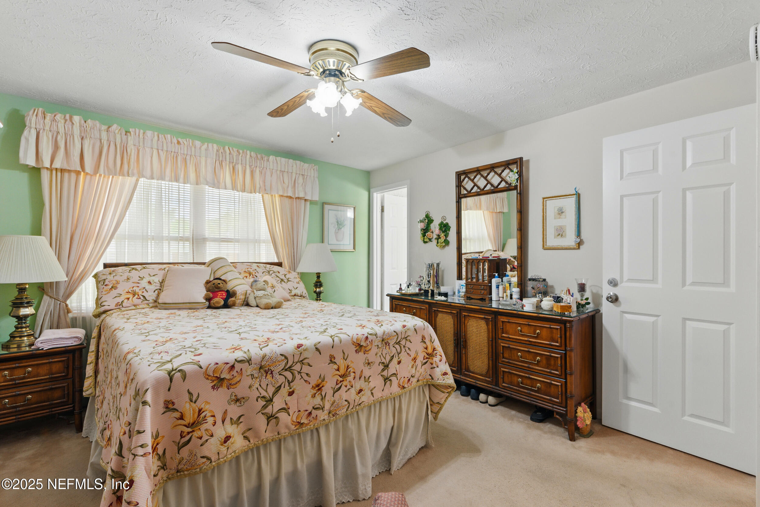 1257 Crown Drive Jacksonville, FL 32221 - Photo 12 of 21 a bedroom with a bed and a chandelier