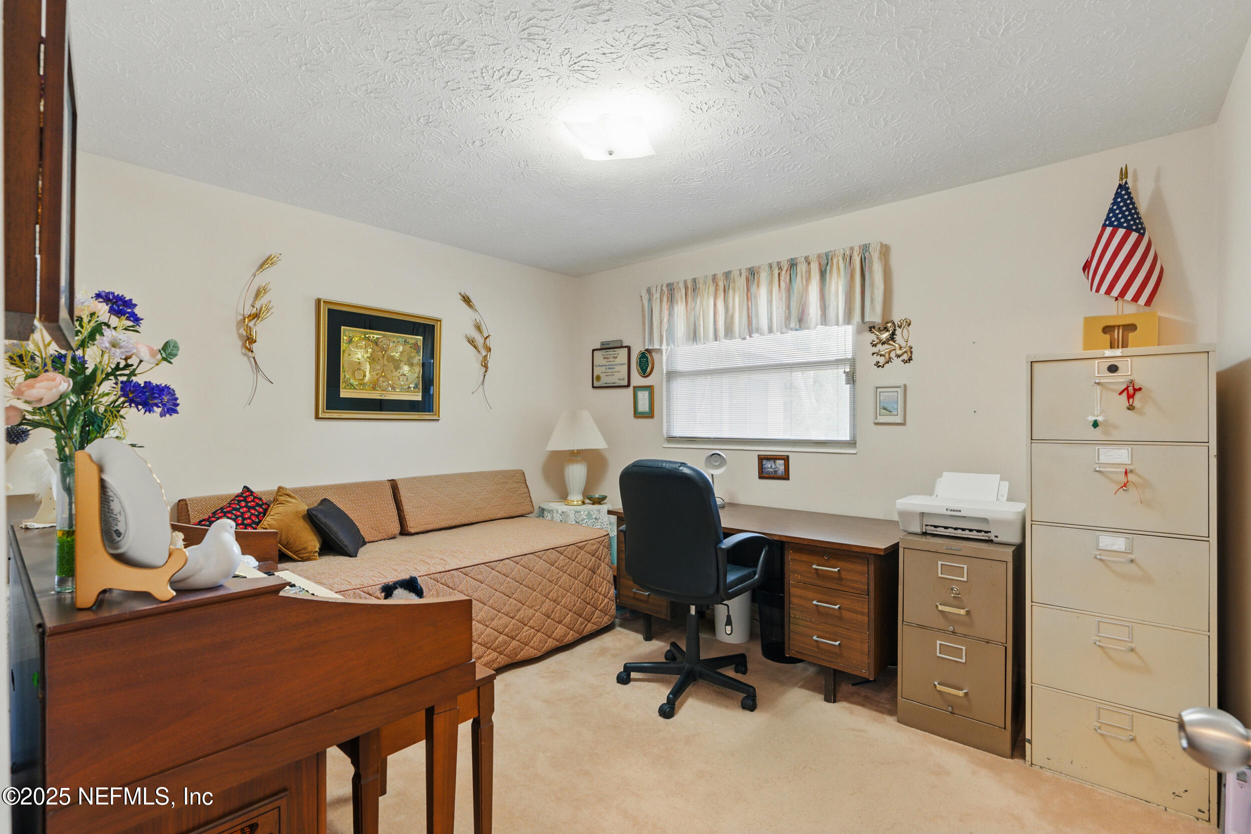 1257 Crown Drive Jacksonville, FL 32221 - Photo 16 of 21 a view of a workspace with furniture and a window