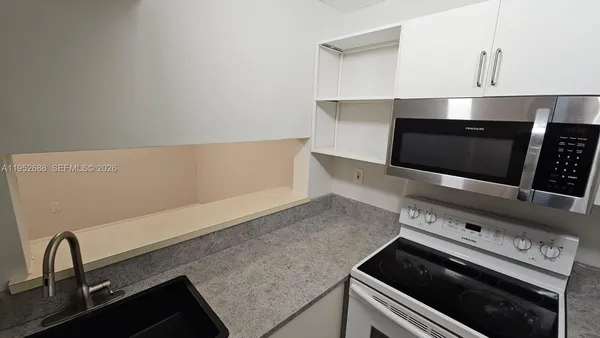 a kitchen with a stove and a microwave