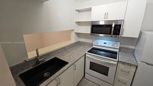 a kitchen with a stove and a microwave