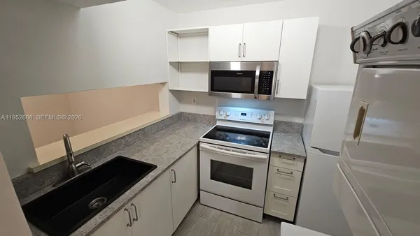 a kitchen with a stove and a microwave