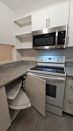 a stove top oven sitting inside of a kitchen