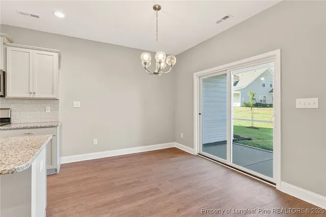 a view of a kitchen with wooden floor and a sink