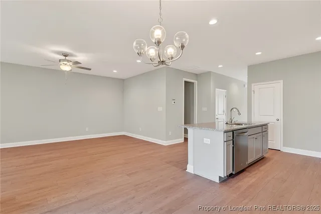 a kitchen with stainless steel appliances granite countertop a stove and cabinets