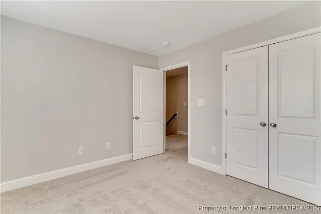 a view of a room with windows and ceiling fan