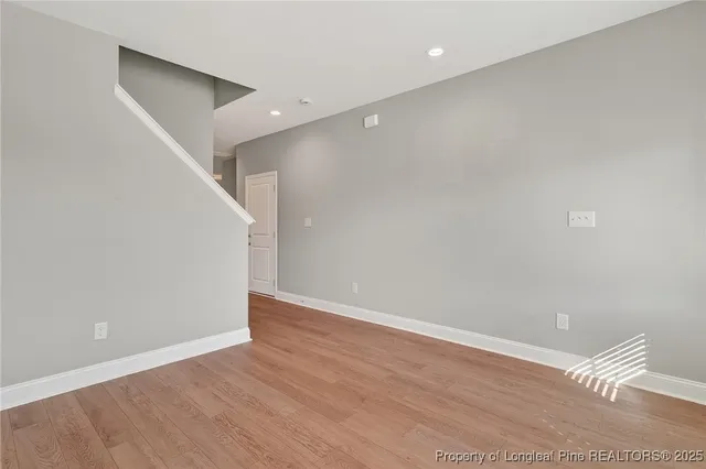 a view of an empty room with wooden floor