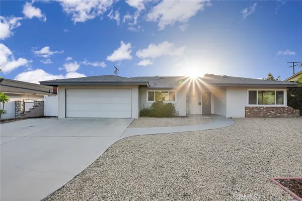 a view of a house with a yard and garage